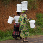 Women carrying filters from a distribution event