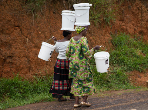 Women carrying filters from a distribution event