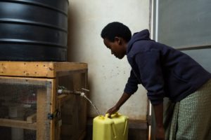 Woman filling jerrycan from SAM2 Filter